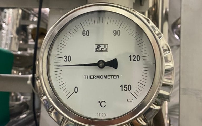 Dial thermometer installed for industrial temperature measurement