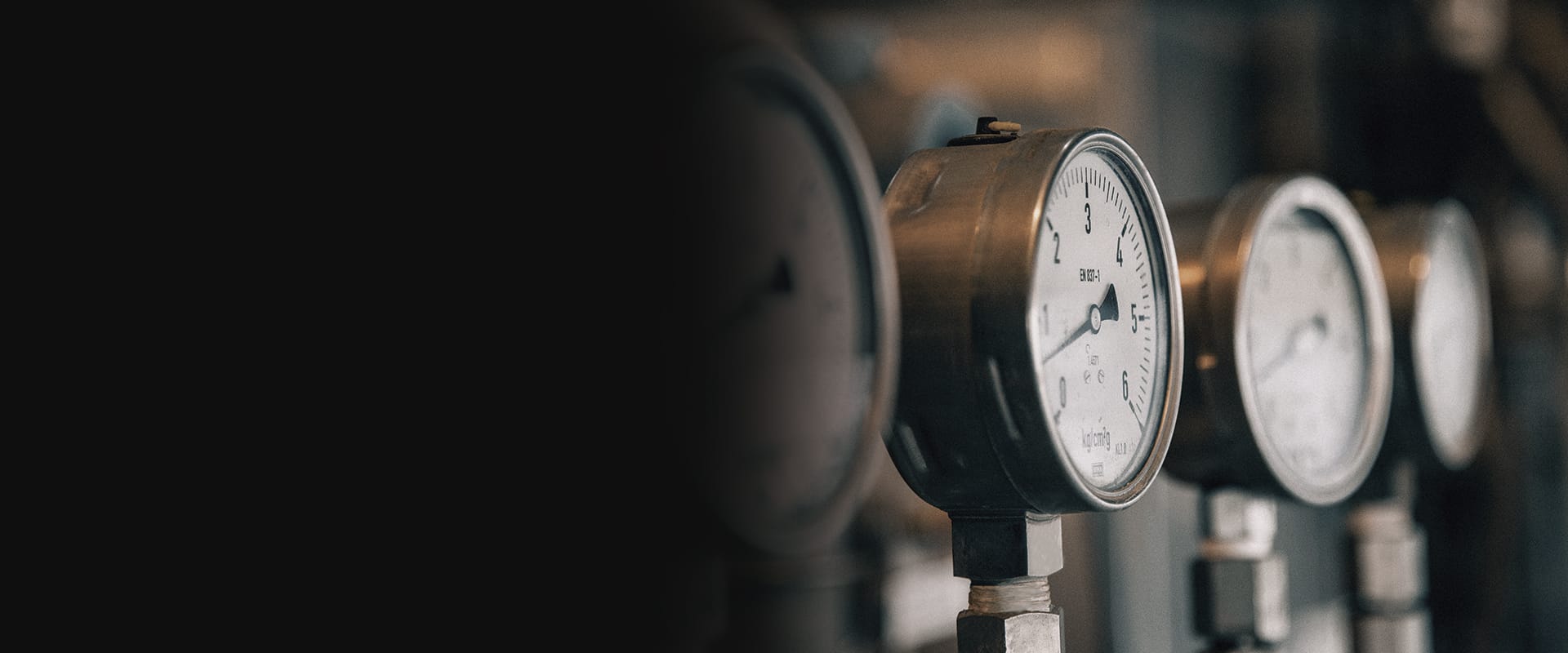 Industrial pressure gauges installed in a process facility
