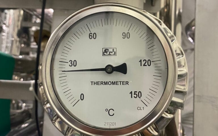 Industrial dial thermometer installed on process equipment